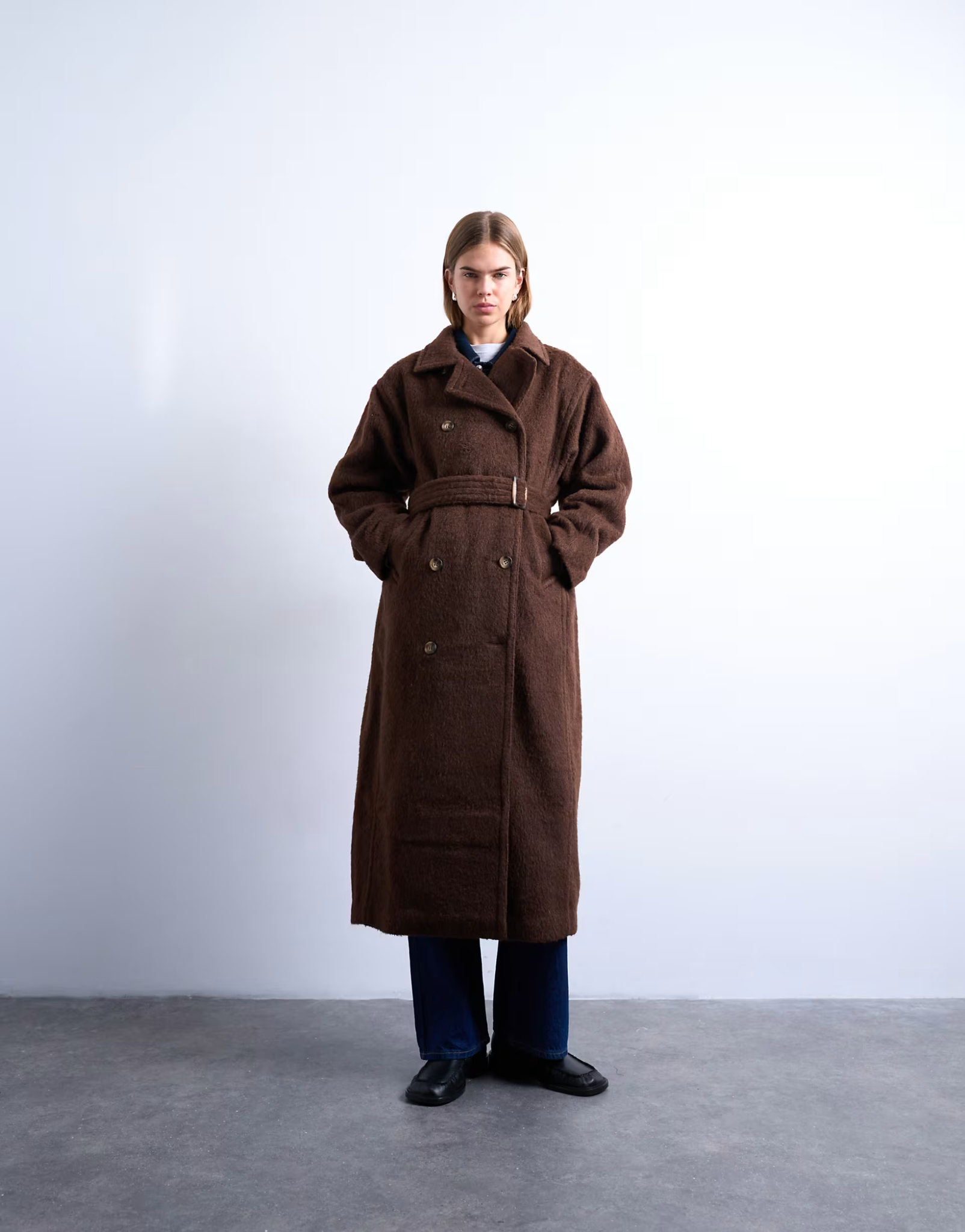 Model wearing a chocolate brown Topshop longline double-breasted coat