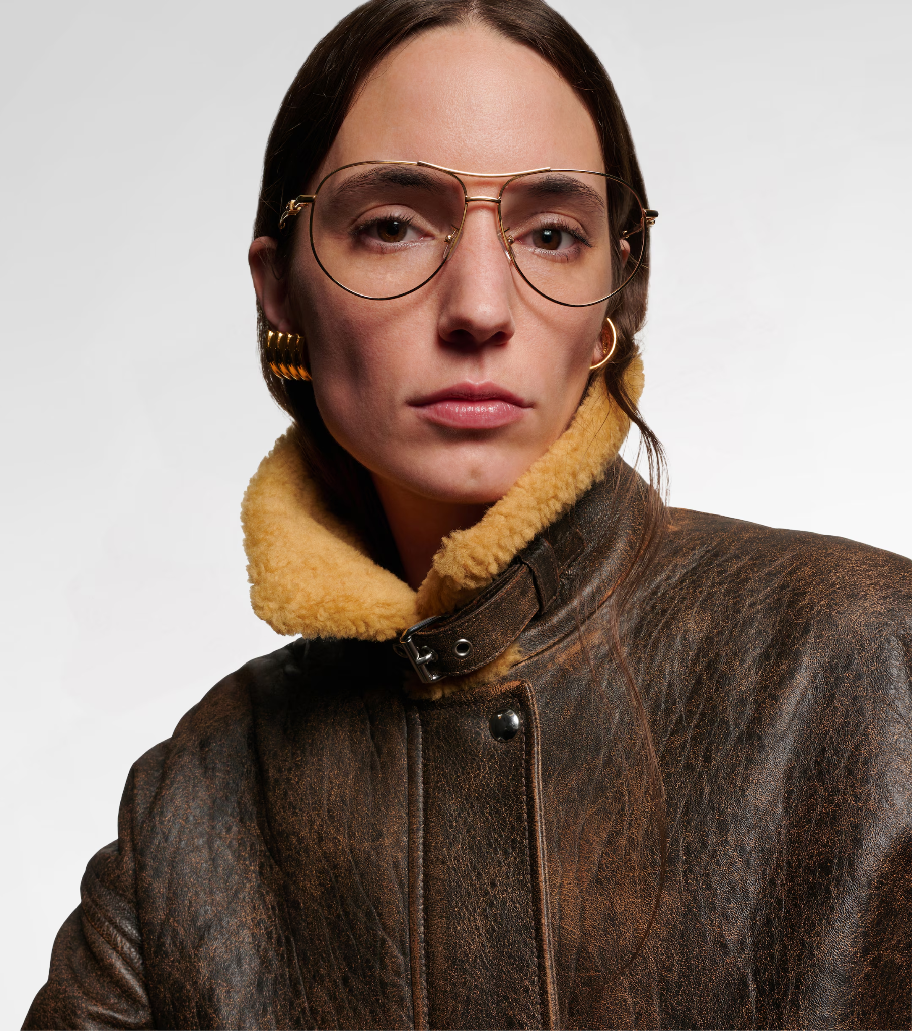 Model wearing gold-tone Fendi Fendigraphy aviator glasses