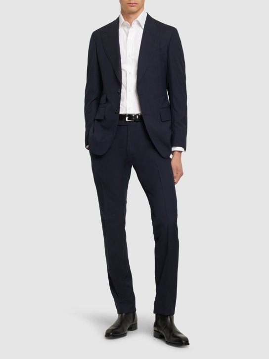 Model wearing a navy Tom Ford two-button suit